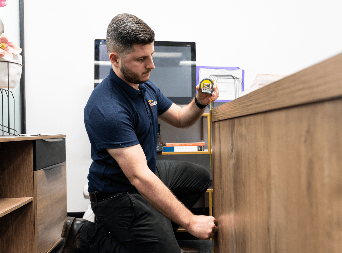 Image depicting an ergonomic assessment, showcasing a professional evaluating a workspace for optimal comfort and efficiency